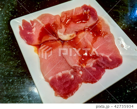 Sliced raw pork on white dish Sliced raw pork on white dish 42735934