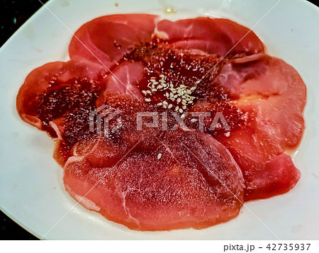 Sliced raw pork on white dish Sliced raw pork on white dish 42735937
