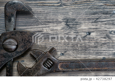 Adjustable and gas wrenches on a weathered wood Adjustable and gas wrenches on a weathered wood 42738297