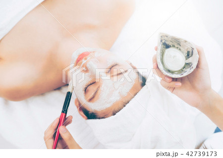 Beautiful woman having a facial treatment at spa. Beautiful woman having a facial treatment at spa. 42739173