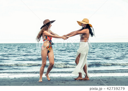 Happy women dance on sand beach in summer. 42739279