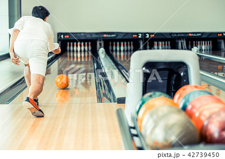 Young man playing bowling. Young man playing bowling. 42739450