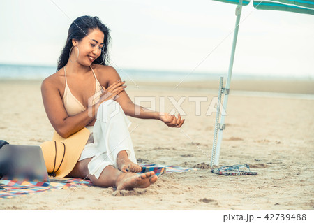 Plus size young woman sitting on the beach. 42739488