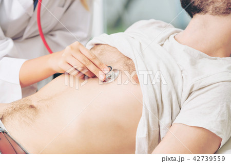 Woman Doctor and Male Patient in Hospital Office Woman Doctor and Male Patient in Hospital Office 42739559