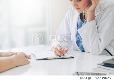 Woman Doctor and Female Patient in Hospital Office 42739625