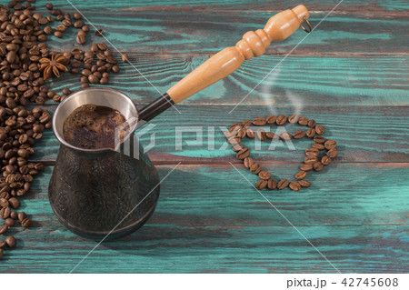 Freshly brewed coffee in copper jezve and a cup 42745608