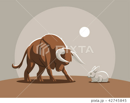A young bull, a calf is attacking a rabbit. A young bull, a calf is attacking a rabbit. 42745845