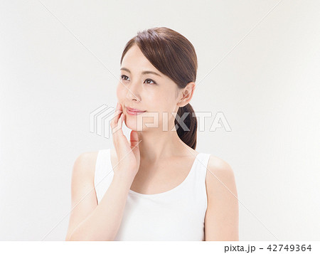 ビューティイメージ 頬に手を添える女性の写真素材