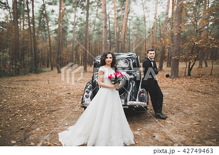 Just married couple in the luxury retro car on their wedding day Just married couple in the luxury retro car on their wedding day 42749463