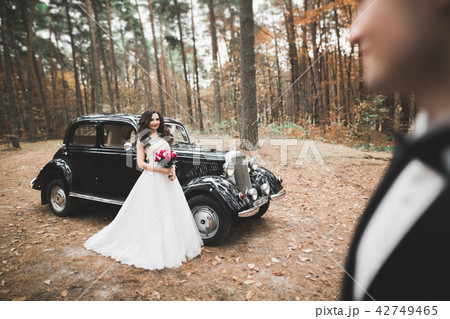 Just married happy couple in the retro car on their wedding Just married happy couple in the retro car on their wedding 42749465