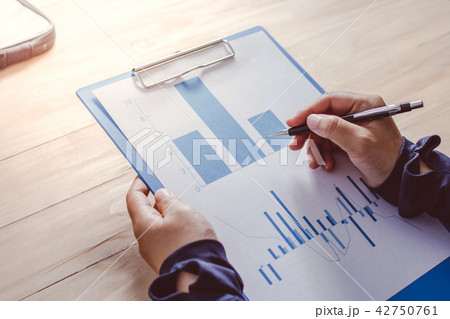 Business people pointing fingers at the graph  42750761