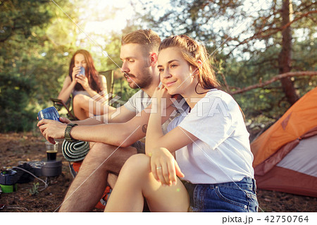 Party, camping of men and women group at forest. They relaxing Party, camping of men and women group at forest. They relaxing 42750764