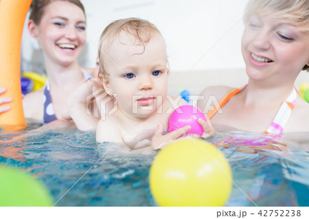 Mothers being happy about their babies playing with each other 42752238