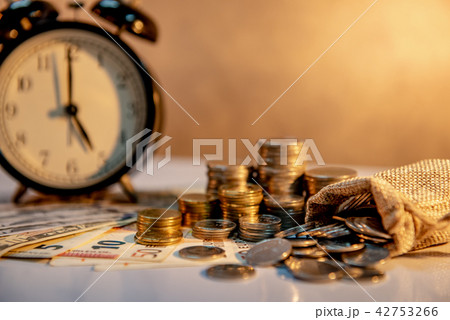 Clock and currency on table, Time Investment 42753266