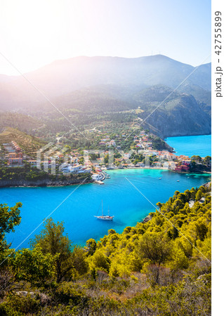 Assos village in morning light, Kefalonia. Greece. White lonely yacht in beautiful turquoise colored 42755899