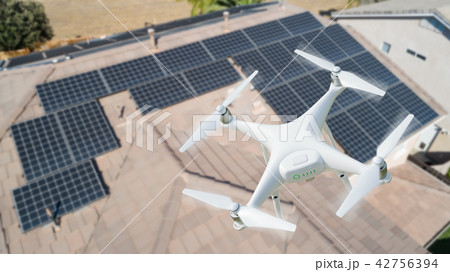 UAV Drone Inspecting Solar Panels On Large House 42756394