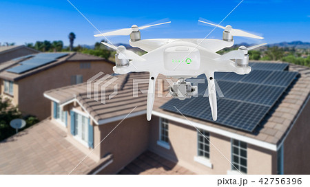 UAV Drone Inspecting Solar Panels On Large House UAV Drone Inspecting Solar Panels On Large House 42756396
