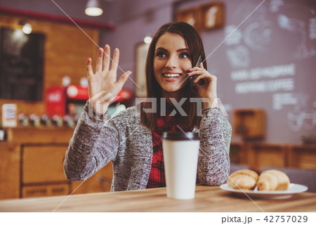 Young Woman with Mobile in Cafe. Young Woman with Mobile in Cafe. 42757029