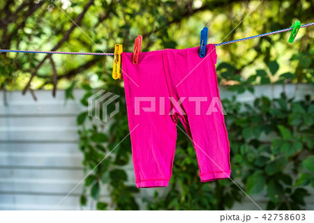 Clean baby pants on the outdoor clothesline 42758603