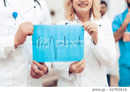 Doctors Camera Posing. Heart Cardiogram Results. 42765618