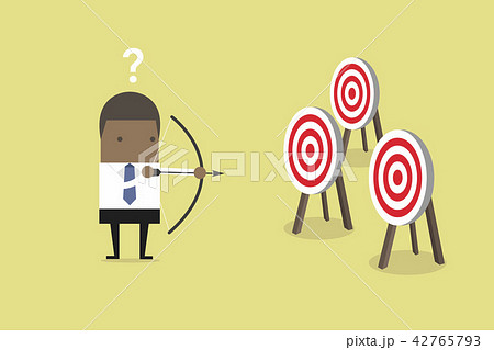 Businessman confused by multiple bulls eye target. Businessman confused by multiple bulls eye target. 42765793