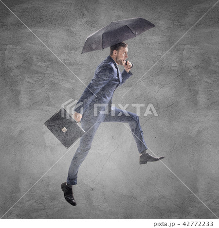 Businessman running with umbrella and briefcase. Businessman running with umbrella and briefcase. 42772233
