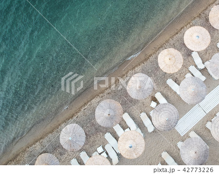 Beach with umbrellas and a bright water Beach with umbrellas and a bright water 42773226