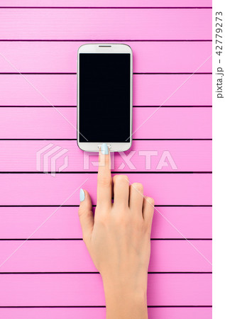 Female hand using white mobile phone 42779273