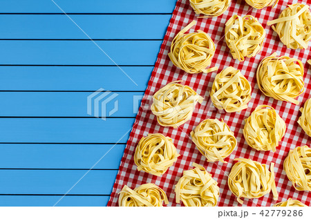 Pasta on blue wooden table Pasta on blue wooden table 42779286