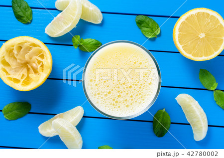 Lemon juice on blue wooden table Lemon juice on blue wooden table 42780002