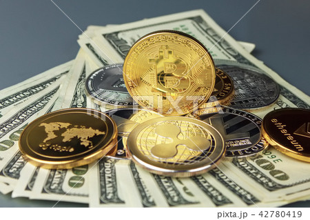 Coins of different crypto-currencies with dollars. Coins of different crypto-currencies with dollars. 42780419