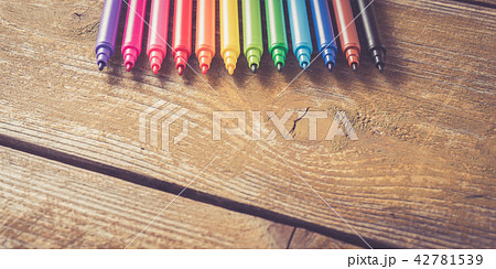 Colorful markers on yellow wooden table. Close up Colorful markers on yellow wooden table. Close up 42781539