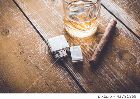 Cuban cigar and whiskey on an old wooden table Cuban cigar and whiskey on an old wooden table 42781569