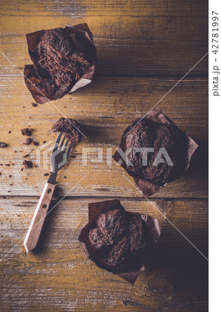 Chocolate cupcakes on wooden table Chocolate cupcakes on wooden table 42781997