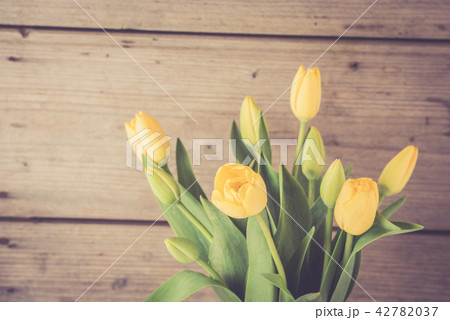 Yellow tulips over wooden background Yellow tulips over wooden background 42782037