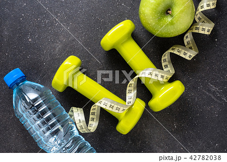 Fitness concept with dumbbells and water Fitness concept with dumbbells and water 42782038