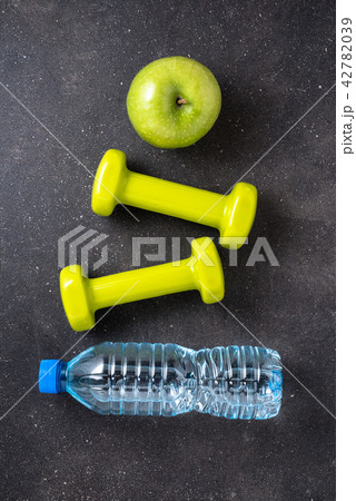 Fitness concept with dumbbells and water Fitness concept with dumbbells and water 42782039