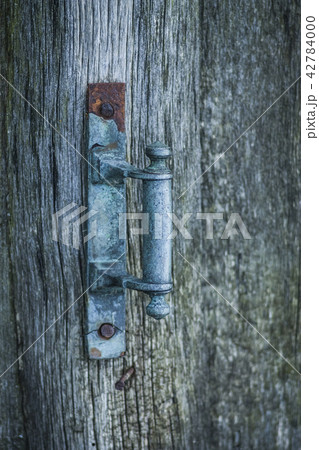 Rustic Copper Handle on a Wooden Door Rustic Copper Handle on a Wooden Door 42784000