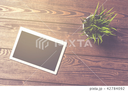 White digital tablet on wooden table 42784092