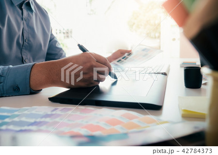 Graphic designer is working used graphics tablet. Graphic designer is working used graphics tablet. 42784373