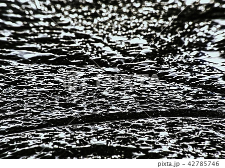 Floes breaking on black rocky beach. Cracked ice 42785746