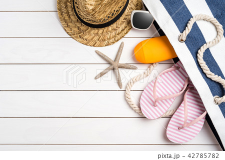 Beach accessories on white wooden table. 42785782