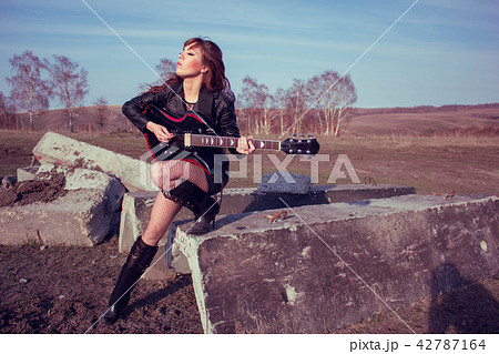 girl with guitar in leather jacket 42787164
