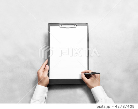 Hand signing blank black clipboard with white a4 paper design mockup 42787409