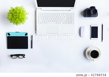 White desk office with laptop, smartphone and othe 42788558