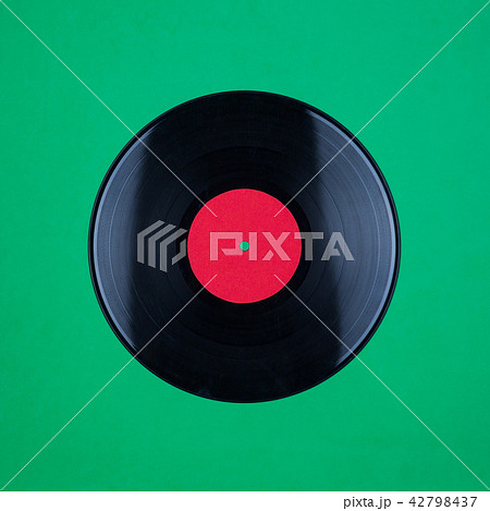Closeup of Vinyl Long Play Record with Label with Copy Space on green background 42798437