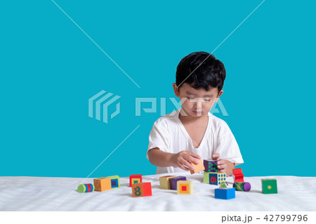 3 years old Asian boy play square block puzzle 3 years old Asian boy play square block puzzle 42799796