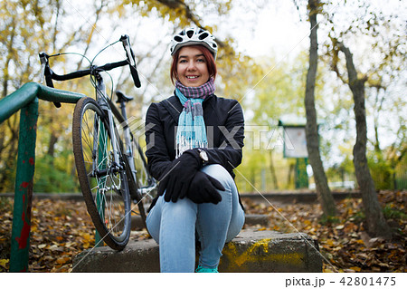 Image of girl sitting on stairs next to bicycle 42801475