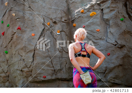 Photo from back of sporty woman climber with bag of soap against rock boulder Photo from back of sporty woman climber with bag of soap against rock boulder 42801713