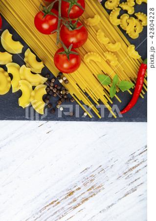 Raw pasta, chili, tomatoes and basil Raw pasta, chili, tomatoes and basil 42804228